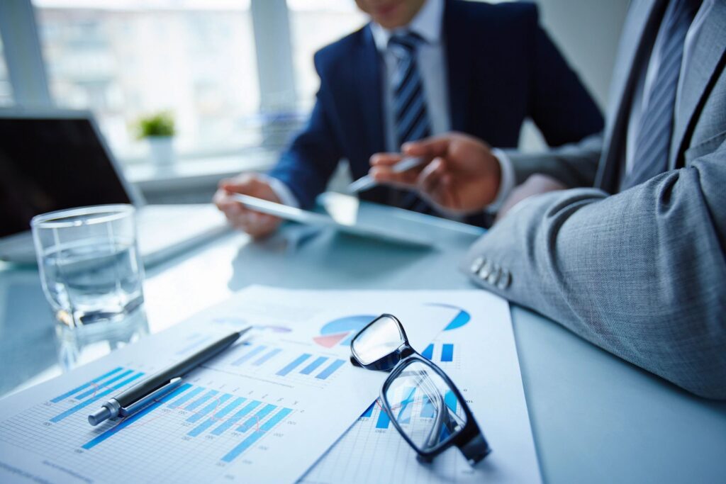 Business meeting with charts and glasses.