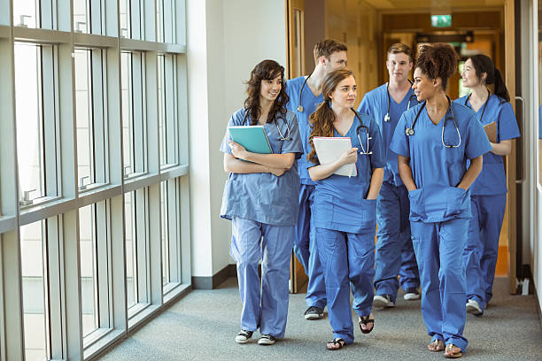 Medical students walking in a hospital corridor.